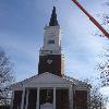 The cross being installed on the new steeple of the church.